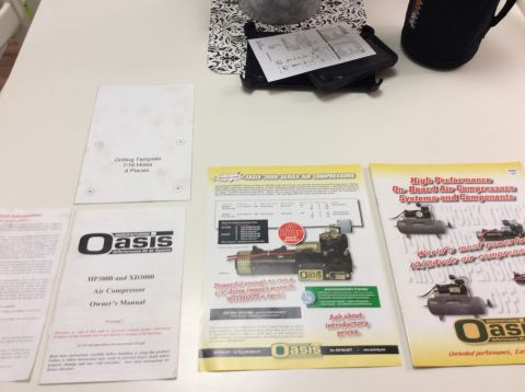 1985 Jeep CJ7 - A white drilling template and several product brochures for Oasis Air Compressors are laid out on a white table. One brochure is for the Oa…