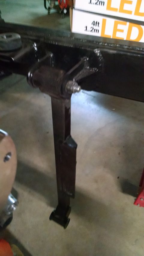 1985 Jeep CJ7 - A close-up view of a vehicle's suspension system, showing a spring and bracket assembly.