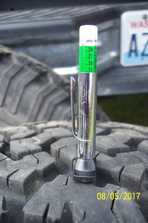 1989 Ford Bronco - A tire tread depth gauge is shown inserted into the tread of a tire. The gauge reads between 15 and 16 MM, indicating low tread depth. A da…