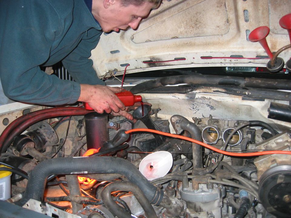 When your toolbox does not include a funnel, and you are sick of going out and buying tools you dont have, you improvise. Here, cut off one of my horns that didnt work anyway and used it to pour my transmission fluid in. Brilliant