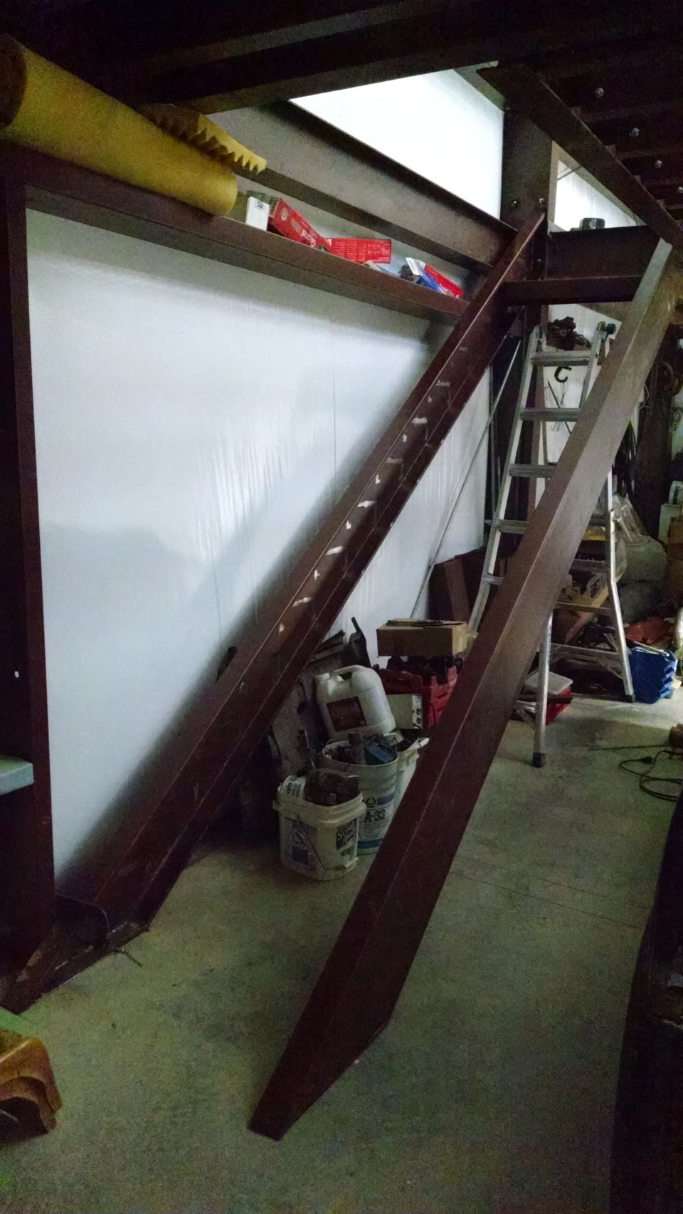 I had to re-hang one of the mezzanine beams, and cut a little off its flanges to make room for the stairs.  Otherwise, I'd have had to cut all 15 treads down, and keep all those cuts square.  After this pic, I bolted the stringers to the floor & to the mezzanine.