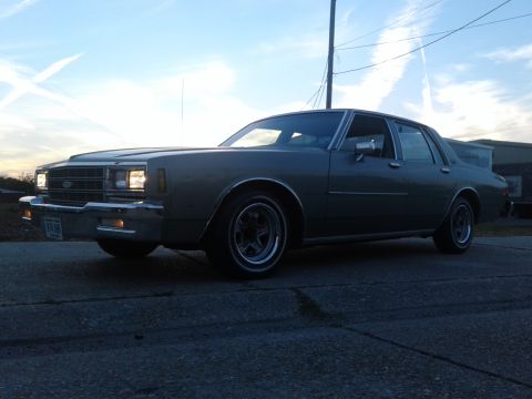 1985 Chevrolet Impala - This Chevrolet Caprice sedan from the early 1980s is shown from the front three-quarter angle.