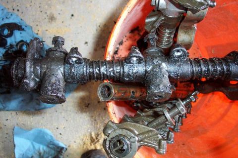 1968 Ford F-100 - Close-up of a greasy steering linkage part, possibly from a 1968 Ford F-100, with some text visible.