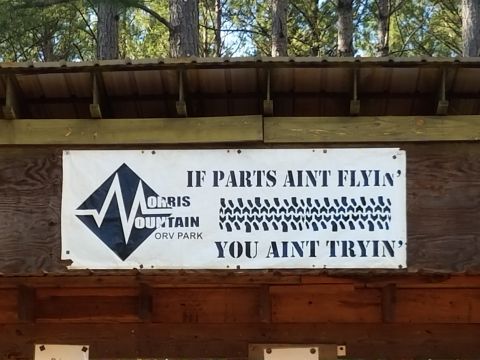 1988 Ford Bronco - A sign at Morris Mountain ORV Park displays a motivational message about off-roading.