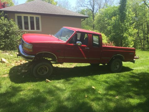 1996 Ford F-150 - Red 1996 Ford F-150 pickup truck with a crew cab and long bed sits in a grassy yard.