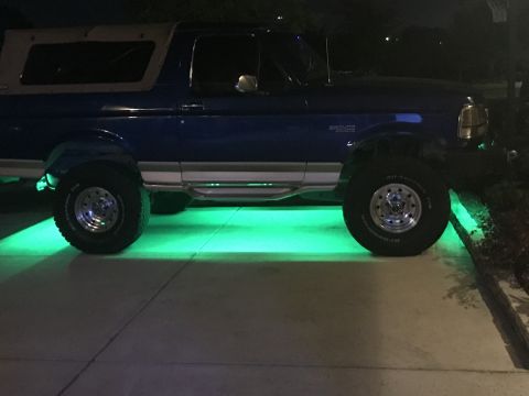 1996 Ford Bronco - This Ford Bronco has green underglow lighting illuminating the ground beneath it.