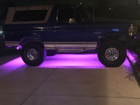 1996 Ford Bronco - This Ford Bronco has custom purple underglow lighting illuminating the ground beneath it.