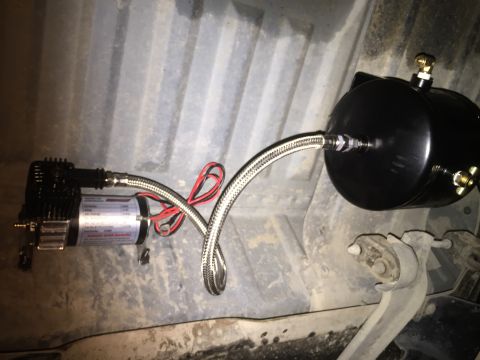 1996 Ford Bronco - An air compressor and tank system, likely for air horns, is shown mounted underneath a vehicle.