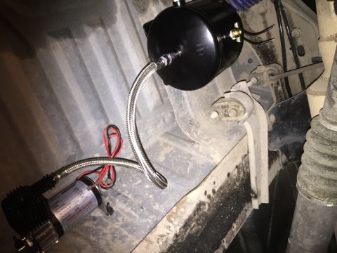 1996 Ford Bronco - Air compressor and tank system installed beneath a vehicle's chassis.