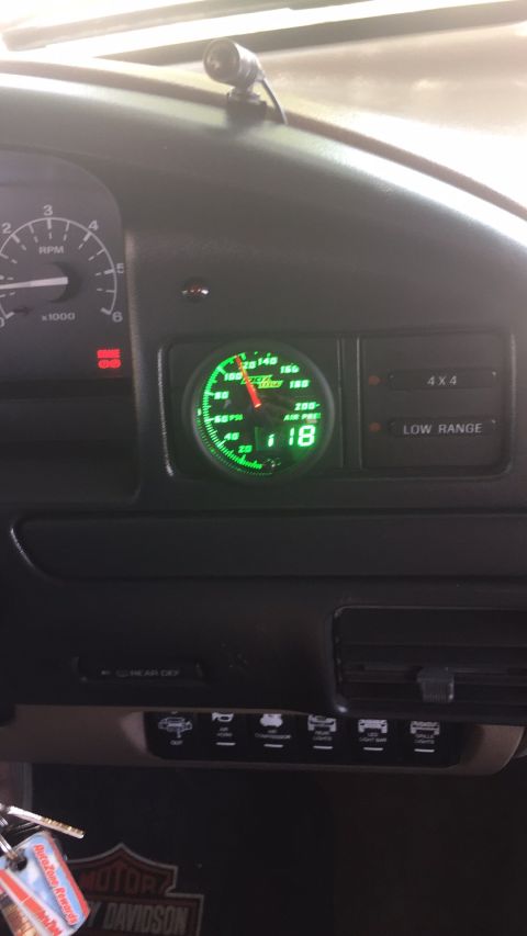 1996 Ford Bronco - Interior view of a vehicle's dashboard, highlighting an air pressure gauge and other controls.