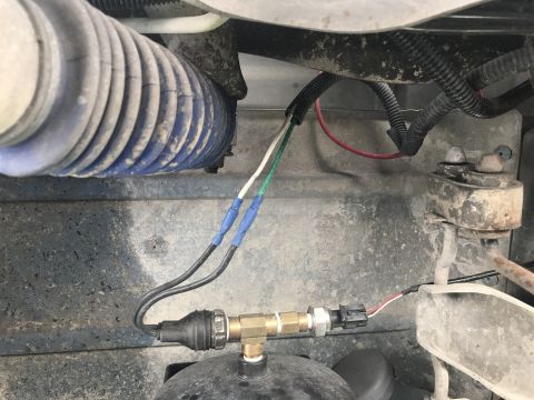 1996 Ford Bronco - Close-up view of an air brake pressure sensor and associated wiring, with a blue corrugated hose visible in the background.