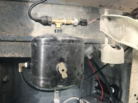 1996 Ford Bronco - Close-up of an air compressor tank and associated plumbing and electrical connections.