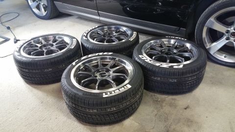 2006 Mitsubishi Evolution - Set of four Pirelli P Zero tires on aftermarket wheels, with a vehicle in the background.
