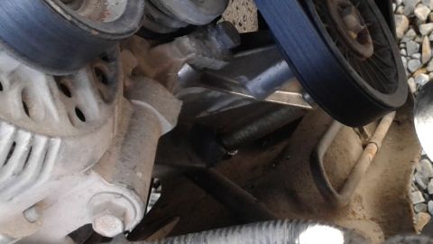 1996 Ford F-350 - This image shows a close-up view of the engine's belt and pulley system, including the alternator.
