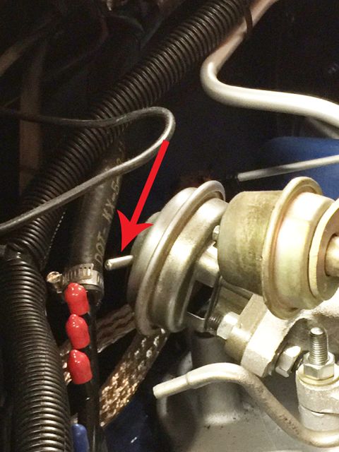 1978 Ford Bronco - A close-up view of a vacuum actuator and associated engine hoses.