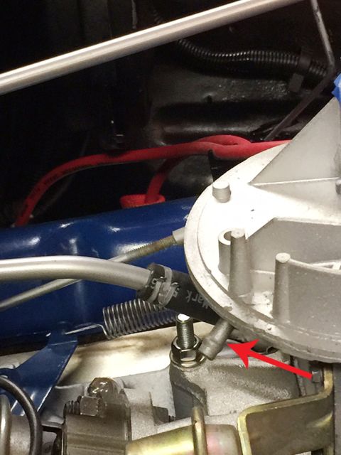 1978 Ford Bronco - Carburetor vacuum line highlighted with a red arrow in this engine part photo.