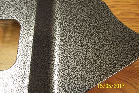 1995 Ford Bronco - A metal part with a textured finish is shown, with a cutout and a raised section visible.