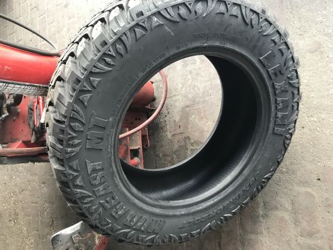 1996 Ford Bronco - A close-up view of a single tire, showing its tread design and sidewall markings.