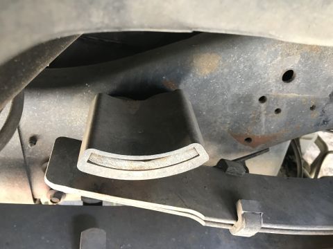 1997 Dodge 3500 - Close-up view of a truck's suspension components, focusing on the leaf spring and frame.
