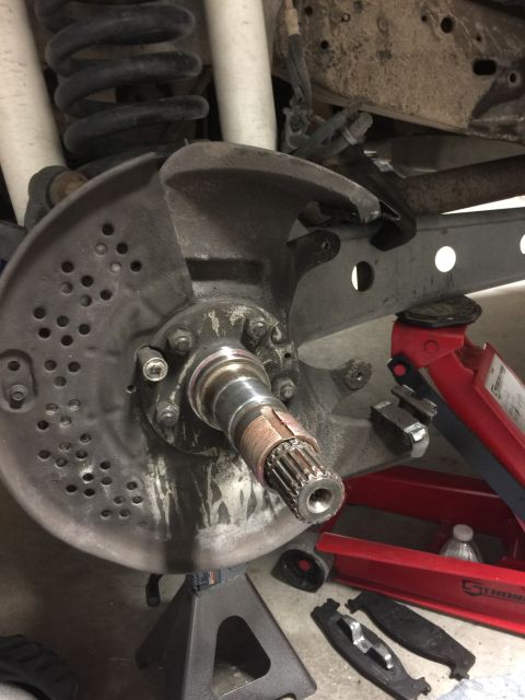 1996 Ford Bronco - The vehicle's front wheel hub assembly is shown with the brake rotor and axle shaft exposed, indicating a repair or maintenance procedure.
