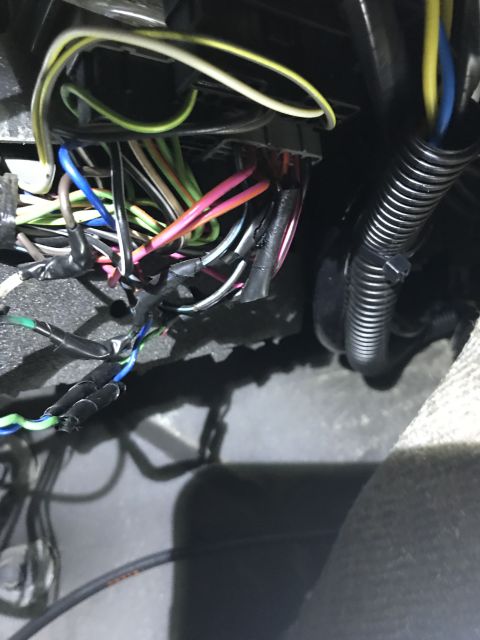 1996 Ford Bronco - A complex vehicle wiring harness, numerous colored wires and electrical connectors, is visible in this close-up view.