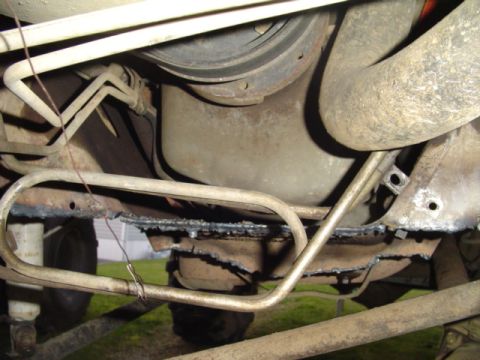 1993 Ford Bronco - Underside view shows fuel lines and frame components of a vehicle.