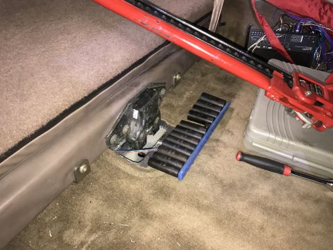 1996 Ford Bronco - Tools and equipment are laid out on the carpeted floor of a vehicle's interior.