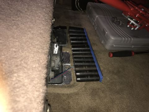 1996 Ford Bronco - Tools are laid out on the carpeted floor of a vehicle's interior.