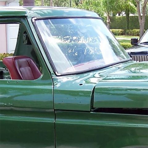 1978 Ford Bronco - Side profile of a green 1978 Ford Bronco, revealing its interior seat and windshield.