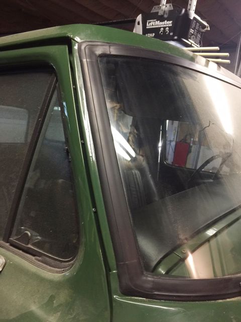 1978 Ford Bronco - View from outside a green vehicle, showing the corner of the windshield and door frame.