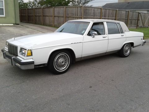 1984 Buick Electra - This white sedan has a tan vinyl roof and wire wheels.