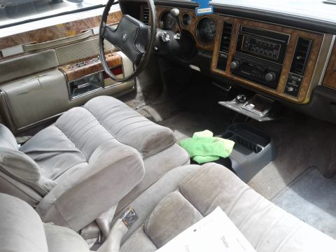 1984 Buick Electra - Interior view of a 1984 Buick Electra, plush seating and wood grain trim.