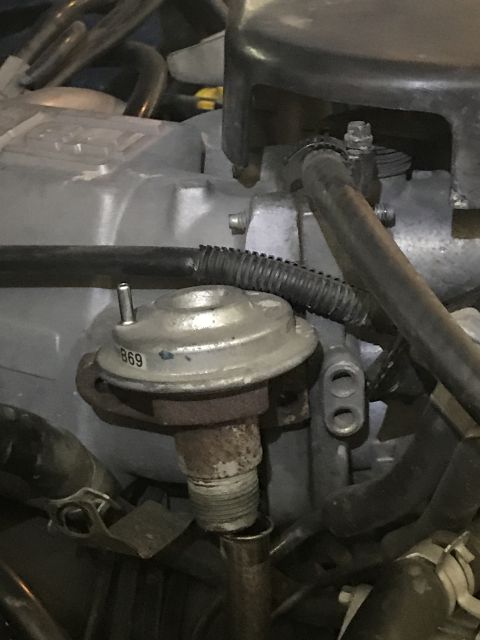 1996 Ford Bronco - Close-up view of an EGR valve with visible part number stamping.