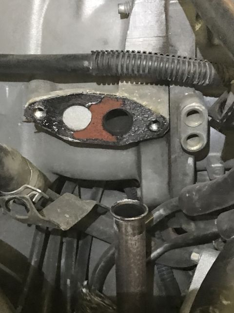 1996 Ford Bronco - Close-up view of an EGR valve gasket, showing its two distinct openings and mounting holes.