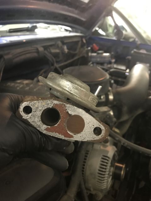 1996 Ford Bronco - EGR valve removed from engine bay, with visible engine parts in the background.