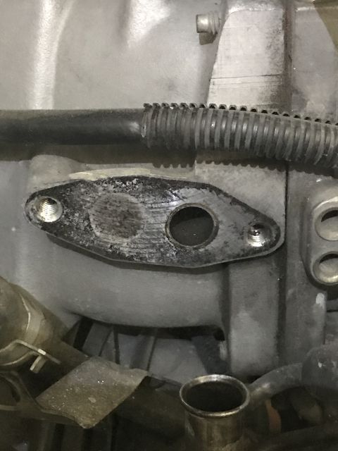 1996 Ford Bronco - Close-up view of the EGR valve gasket surface, showing mounting holes and the central passage.