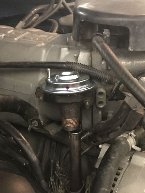 1996 Ford Bronco - Close-up view of an EGR valve installed on an engine.