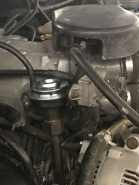 1996 Ford Bronco - Engine bay view focusing on the EGR valve and surrounding parts.