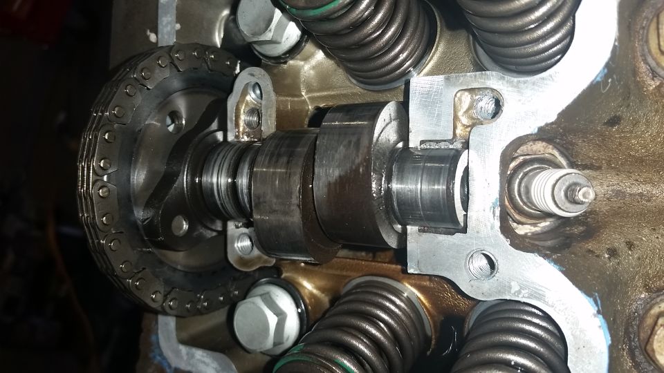 Close-up of an engine's camshaft, timing chain, and valve springs