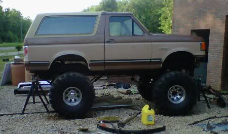 1988 Ford Bronco - This lifted Ford Bronco is on jack stands, showing its modified suspension and large tires.