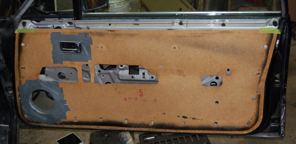 Interior door panel with chrome handle and speaker cutout