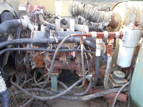 1992 Ford Bronco - Close-up view of a heavily weathered engine compartment, showing signs of rust and disuse.