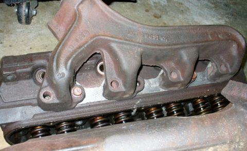 1992 Ford Bronco - Driver side stock manifold on GT40P head. Impossible spark plug access.
