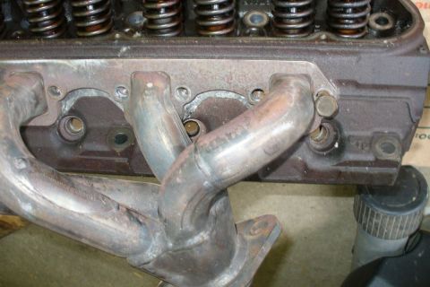 1992 Ford Bronco - Driver side JBA shorties on GT40P head, close-up.