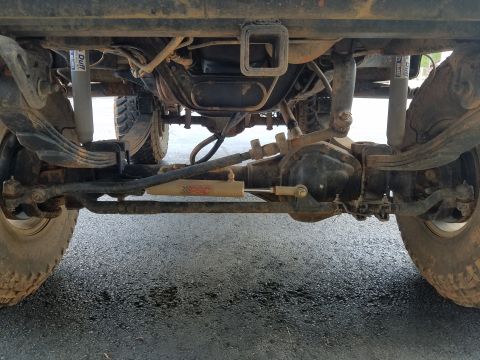 1988 Ford Bronco - This photo shows the rear axle, suspension, and drivetrain components of a 4x4 vehicle.