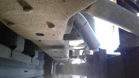 1985 Ford Bronco - Underside view of a vehicle's exhaust pipe section.
