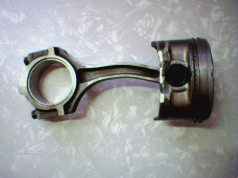 1996 Ford Crown Victoria - A piston and connecting rod assembly is shown against a textured background, with the Supermotors.net logo in the lower right corner.