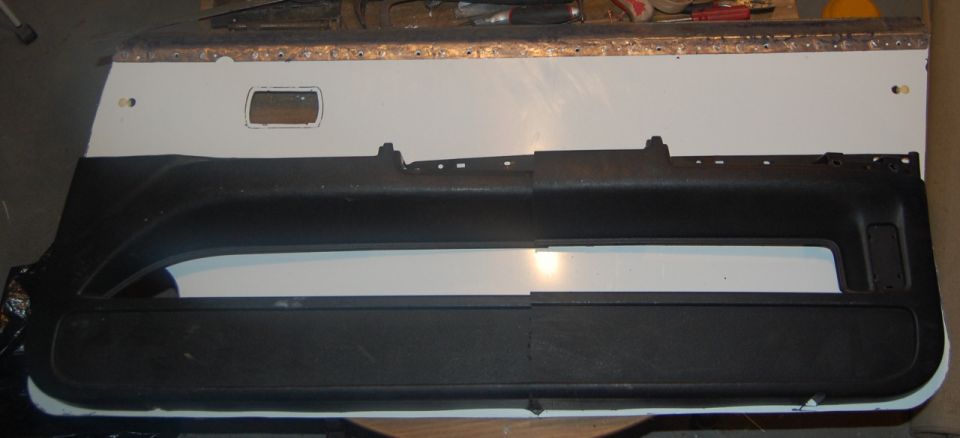 Black plastic door panels with a white backing, one with a rectangular cutout