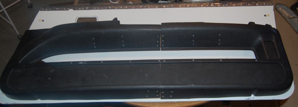 Two black car door panels laid out on a table