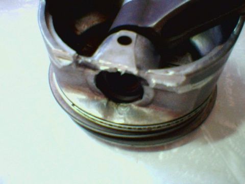 1996 Ford Crown Victoria - This engine piston shows significant damage, including a hole through its crown.
